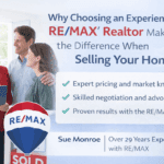 Smiling realtor with couple and RE/MAX sign