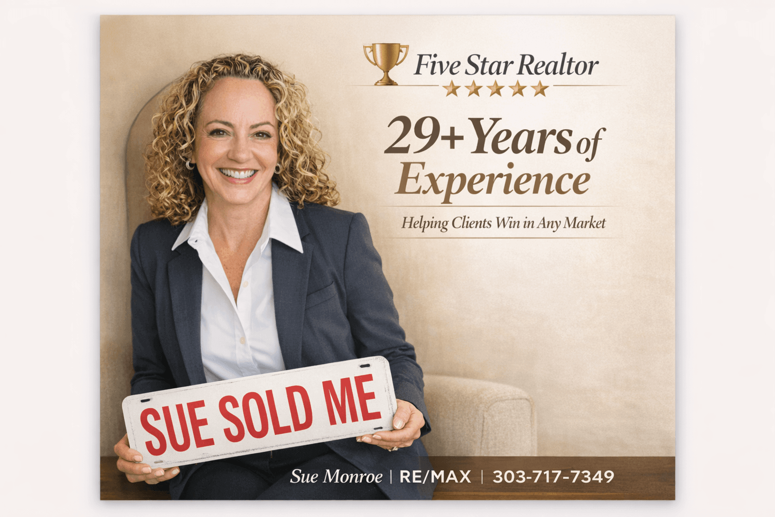 Smiling female realtor holding "sold" sign